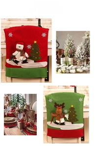 Detailed view of red snowman and green reindeer chair covers for Christmas table setting