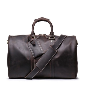 Deep brown crazy horse leather travel bag with sturdy handles and adjustable shoulder strap