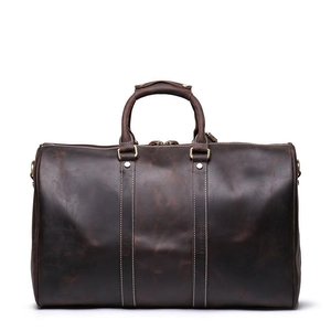 Detailed view of dark brown crazy horse leather travel bag with durable metal hardware