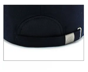 Detail of adjustable metal buckle and navy wool texture on men's winter baseball cap