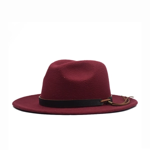 Detail view of burgundy wool felt fedora hat featuring a black belt and brown cord trim