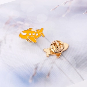 Creative yellow airplane enamel brooch with golden metal base and secure pin back closure