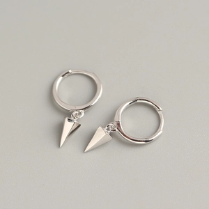Detail of silver S925 geometric hoop earrings featuring a polished cone-shaped drop pendant