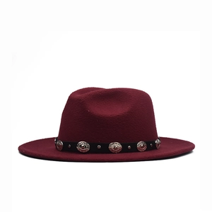 Wine red wide brim fedora hat with a black leather band and silver metal studs