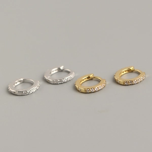 Close-up of gold and silver 925 sterling silver hoop earrings with shimmering pave diamonds