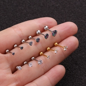 Macro view of crystal zircon stud earrings with gold and silver ball back closures
