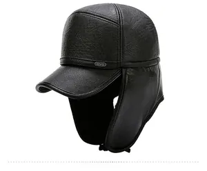 Detail of black faux leather winter baseball hat with earflaps and Sport metal badge