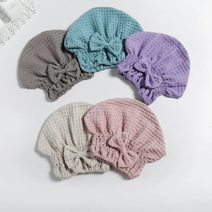 Five assorted microfiber hair towels with waffle texture and decorative bow details