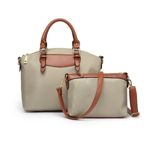 Detail view of khaki nylon canvas tote and crossbody bag set with brown leather trim