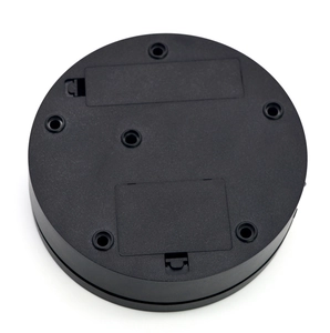 Detail view of the bottom showing two battery compartments and screw holes on the black base
