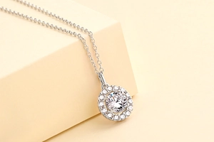 Macro shot of silver halo pendant featuring a large central zircon and fine diamond accents