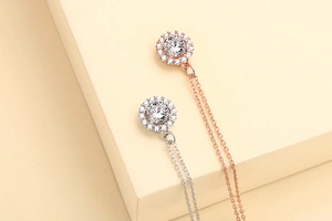 Detail of rose gold and silver necklaces featuring round cluster-set crystal pendants