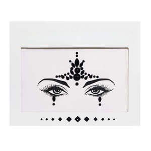 Detail of black face crystal stickers with forehead and eye jewels on white card
