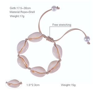 Handmade shell bracelet with natural cowrie shells and pearls on an adjustable beige rope