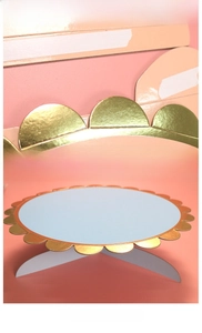 Detail of light blue single-tier paper cake stand with elegant scalloped gold edges
