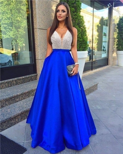 Detail of sequin patchwork evening gown with deep V-neck and blue satin skirt