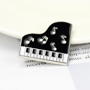 Macro view of a creative black and white piano enamel brooch with silver metal frame