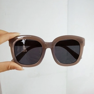 Detailed view of the dark brown translucent square frames and dark gray UV lenses
