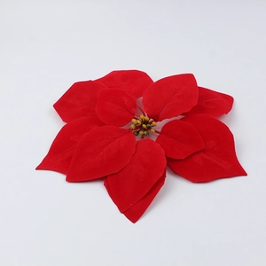 Macro shot of red velvet poinsettia head with realistic texture and yellow center stamen