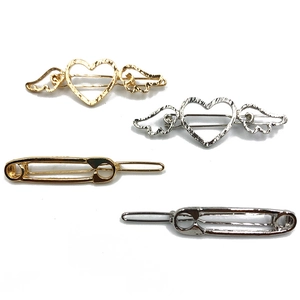 Set of four gold and silver metal hair clips with hollow heart wings and pin designs