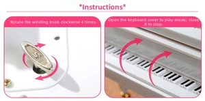 Close-up of wind-up mechanical mechanism and keyboard lid on white piano music box