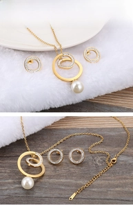 Detail of gold plated stainless steel necklace and earrings set with pearls and zircons