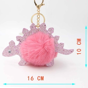 Pink cartoon dinosaur keychain with plush ball showing dimensions 16cm by 10cm