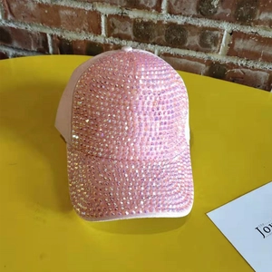 Close-up of sparkling pink rhinestones on a baseball cap with vibrant high-density crystals
