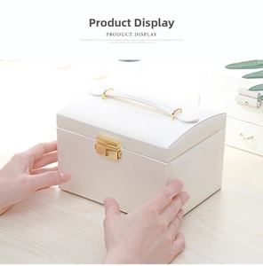 Close-up of pearl white PU leather jewelry box with a gold metal lock on wooden surface