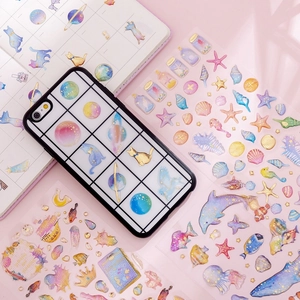 Unicorn crystal epoxy stickers with gold foil, ocean and starry sky themes on a phone case