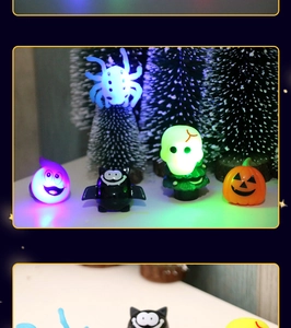 Detail of Halloween LED light-up rings with pumpkin, bat, and ghost designs on dark background