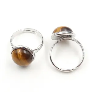 Adjustable silver ring featuring a natural tiger eye stone with golden brown stripes
