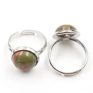 Macro detail of silver adjustable rings featuring round polished Unakite gemstones