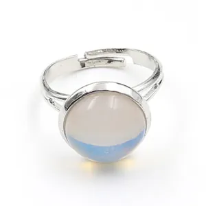 Close-up of adjustable silver ring with a round translucent cabochon stone inlay