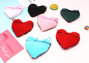 Close-up of heart-shaped sequin coin purses in vibrant colors with zipper and lanyard