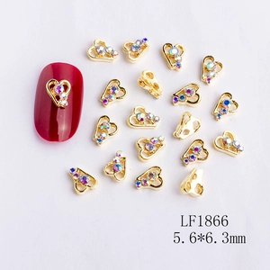 Macro view of 5.6x6.3mm heart-shaped alloy nail art charms with iridescent rhinestones