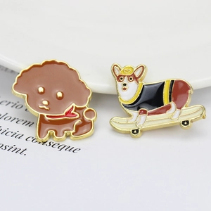 Detail of Poodle and Corgi on skateboard enamel pins in zinc alloy finish