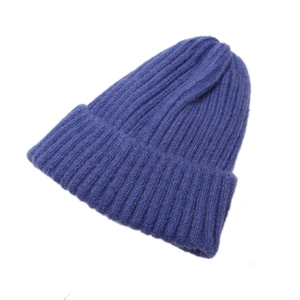 Minimalist blue knit beanie for children featuring thick vertical ribbed texture
