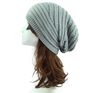 Detailed side view of a light gray ribbed knit slouchy beanie for autumn and winter