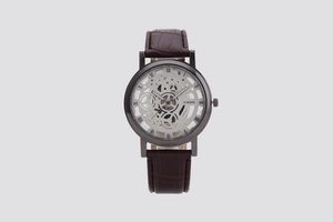 Detailed shot of a luxury skeleton dial men's quartz watch with brown leather strap