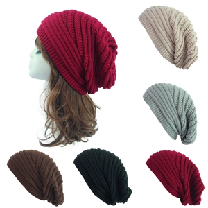 Detailed close-up showing the thick ribbed knit texture of several women's winter beanies