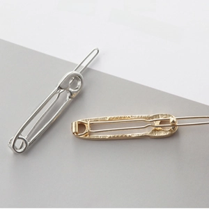 Minimalist safety pin hair clips in polished silver and matte gold metal finishes