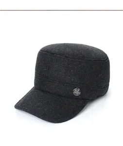 Detail view of charcoal gray wool flat top army cap with a metal star badge on the side