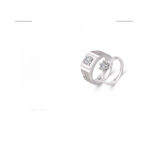 Detail of white gold plated couple rings set with cubic zirconia stones and adjustable band