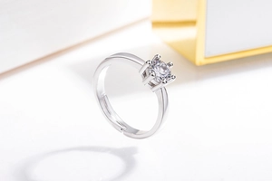 Detail of adjustable silver ring featuring a classic six-prong set round cubic zirconia