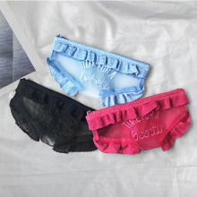 Close-up of three mesh panties in blue, black, and rose red with ruffled edges and lettering