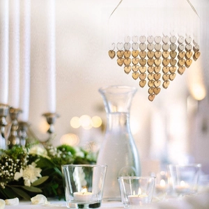 Detail of wooden wedding countdown plaque with heart tags on a romantic banquet table