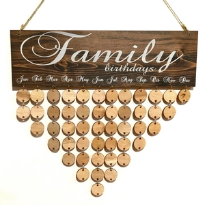 Macro detail of Family Birthdays wooden board with round hanging discs for home decor