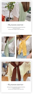 Detail of knitted shawls in light green, yellow, and brown with fine ribbed edges
