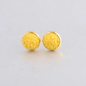Macro shot of 10mm gold plated stainless steel stud earrings with yellow mineral cluster texture
